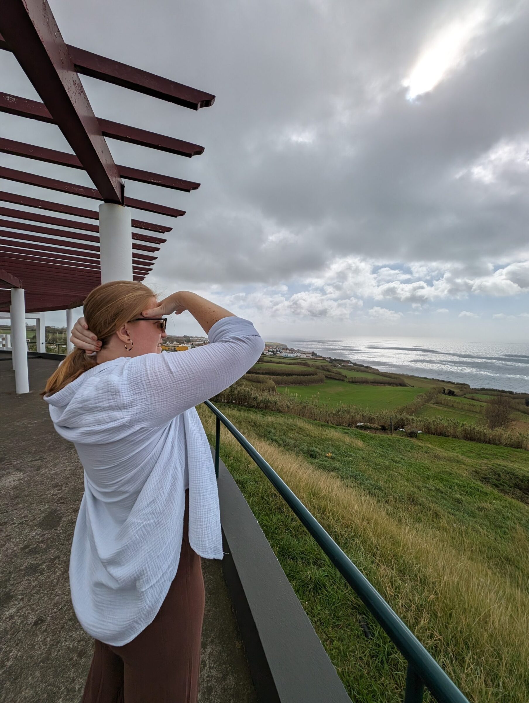 woman looking out over field on cloudy day