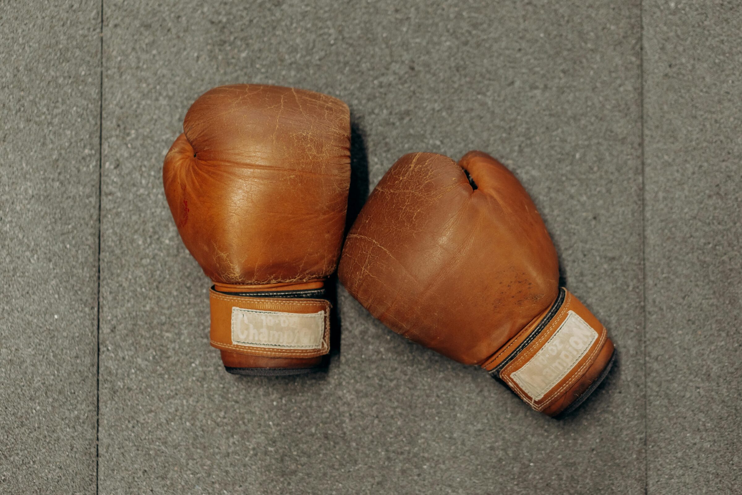 brown boxing gloves on gray table