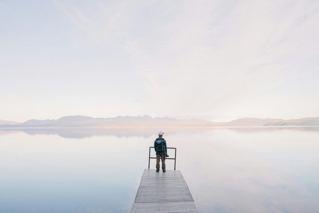 man in jacket standing on dock