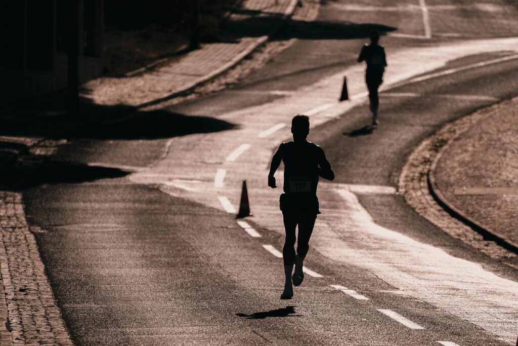 silhouette of man running down street