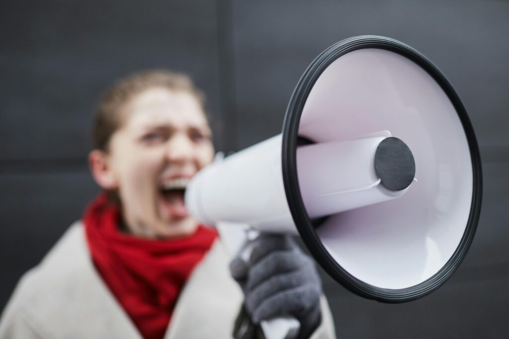 a woman talking on a megaphone