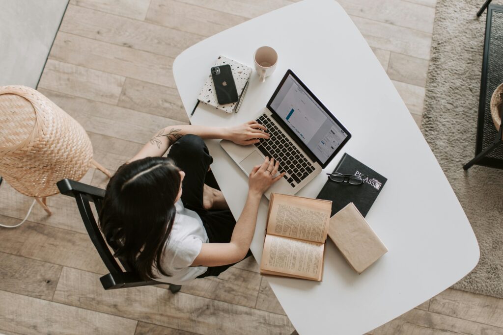 lady typing on keyboard of laptop in living room