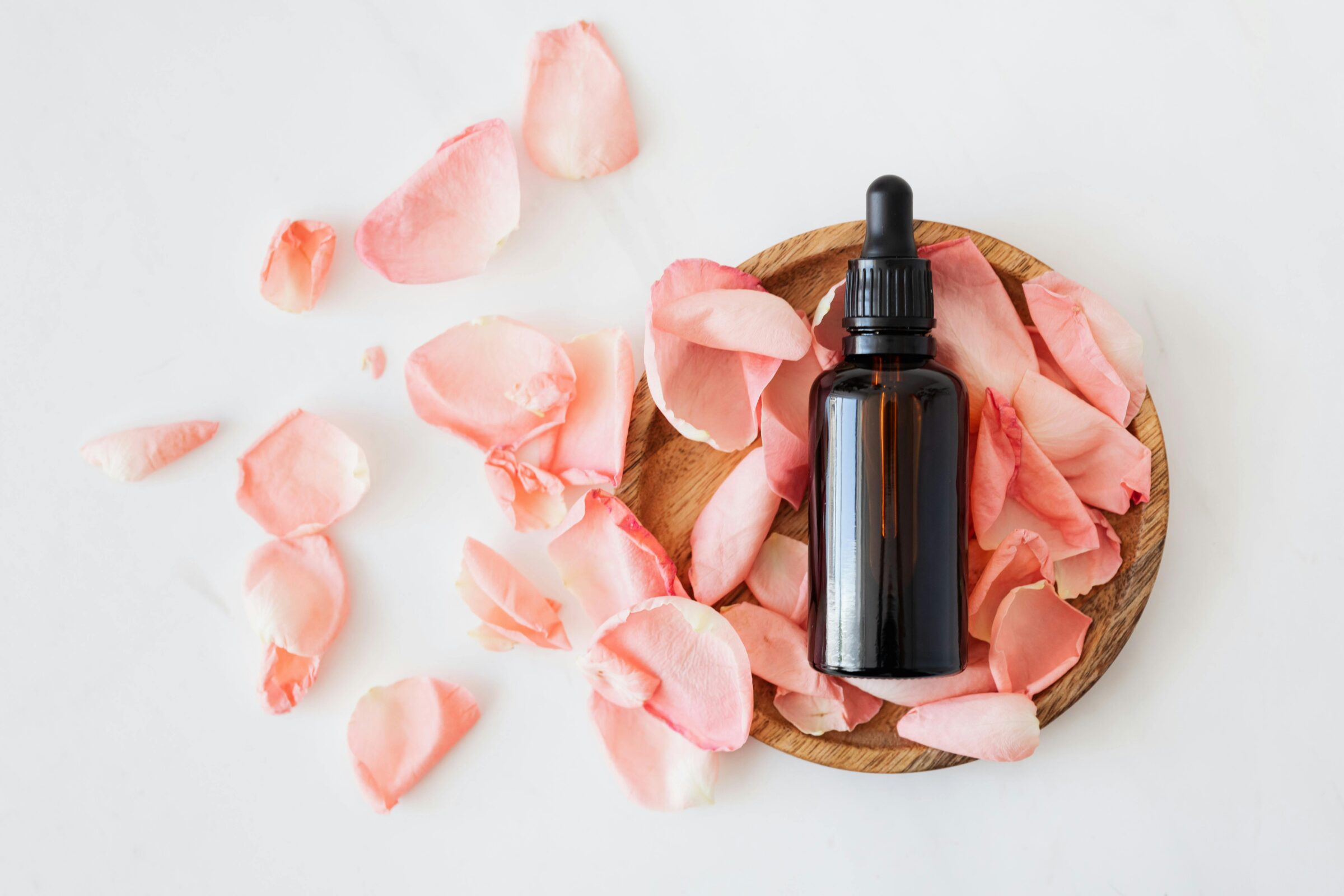 bottle and pink rose petals