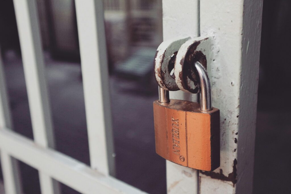 bronze lock on white fencing