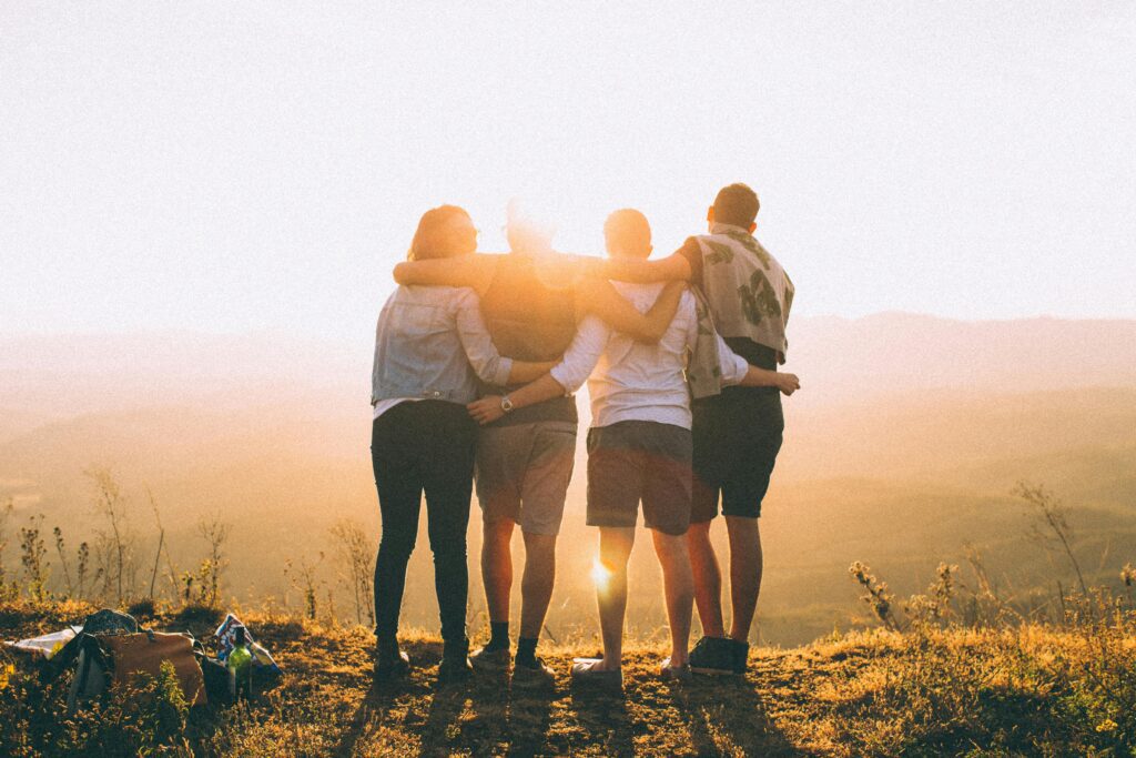 four persons standing on cliff