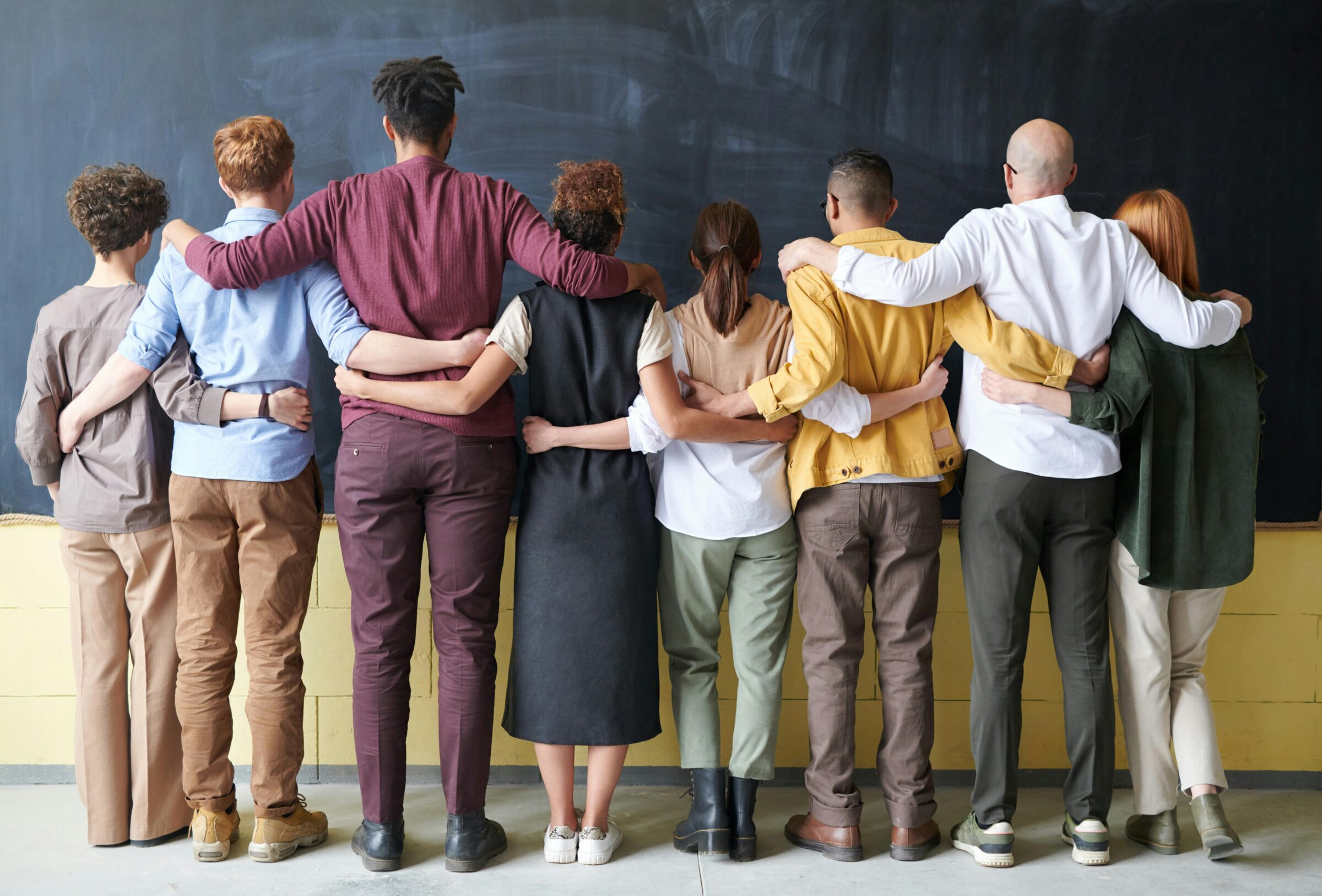 group of people standing arms interlocked